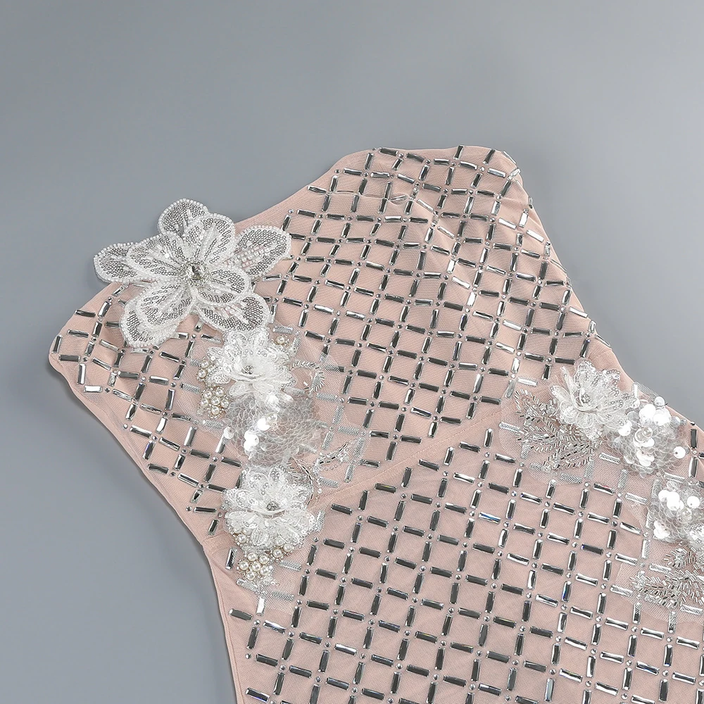 Close-up of the 3D flowers and sequins on apricot strapless sequin lattice midi dress