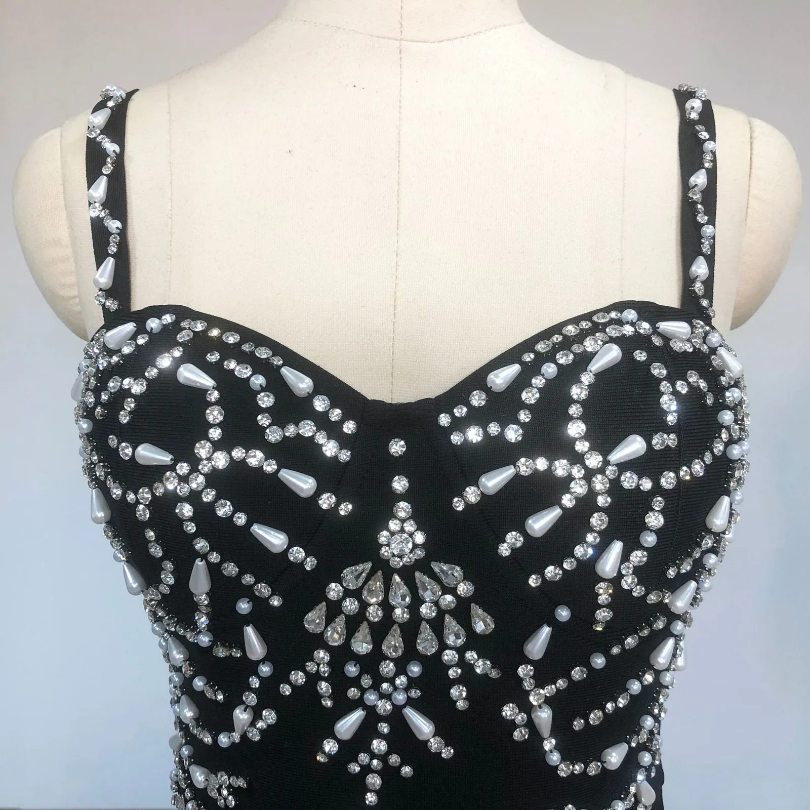 Close-up real photo of the beaded bodice on black spaghetti strap bandage maxi dress