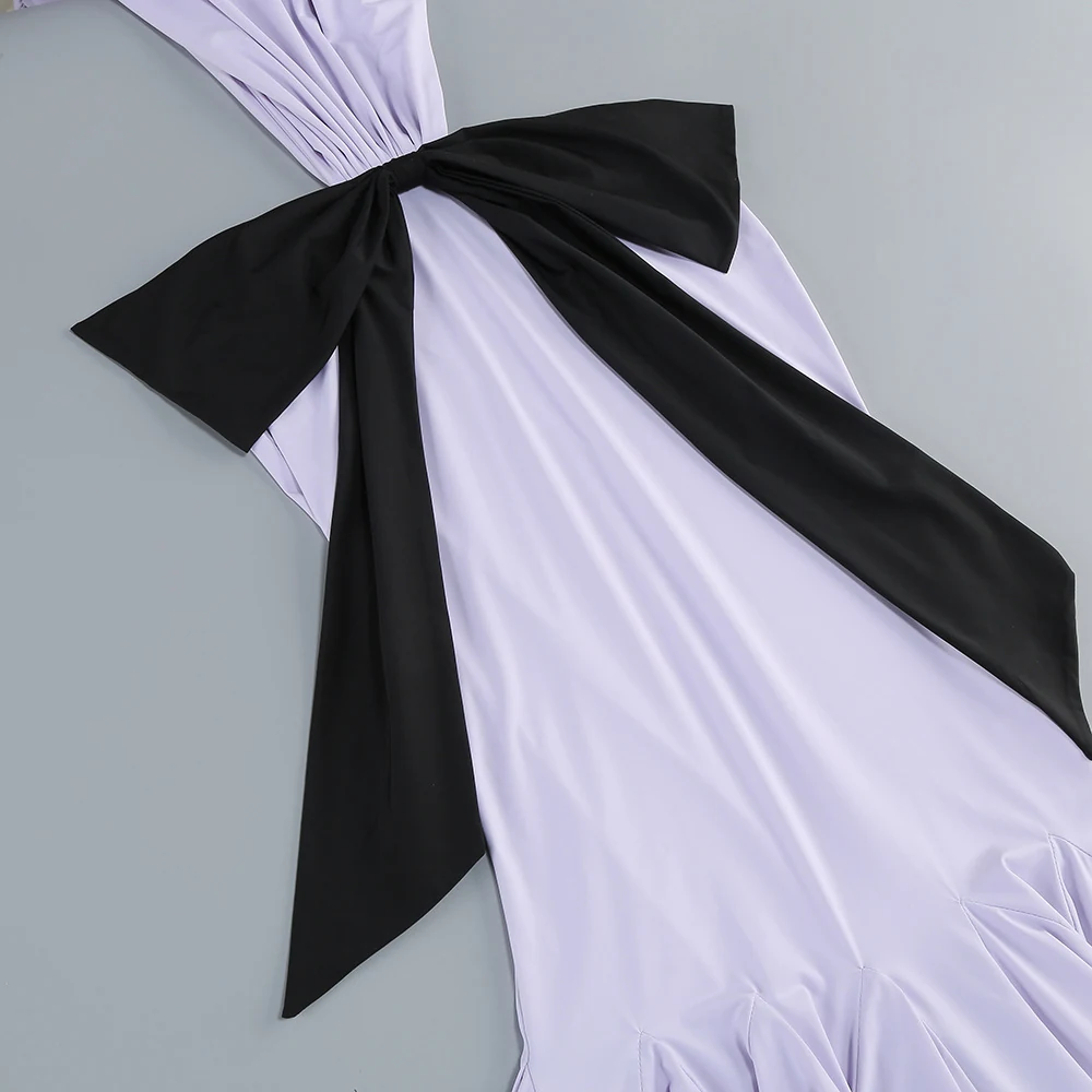 Close-up of the black bow on lavender draped dress