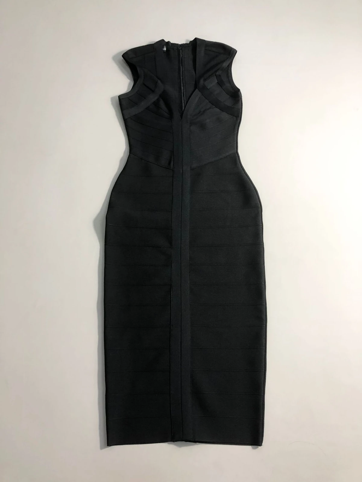 Flat lay of black deep V neck sleeveless bodycon bandage midi dress