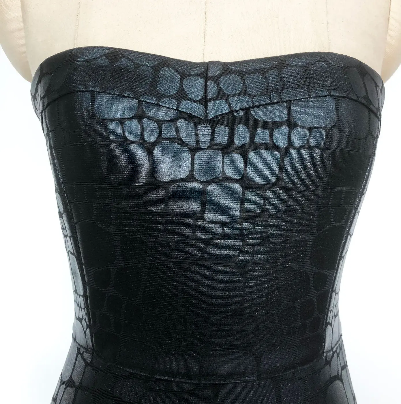 Close-up real photo of the textured black foil print strapless bodice