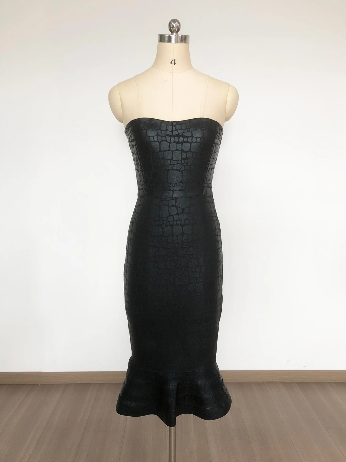 Real photo of black foil print strapless mermaid bandage midi dress on a mannequin