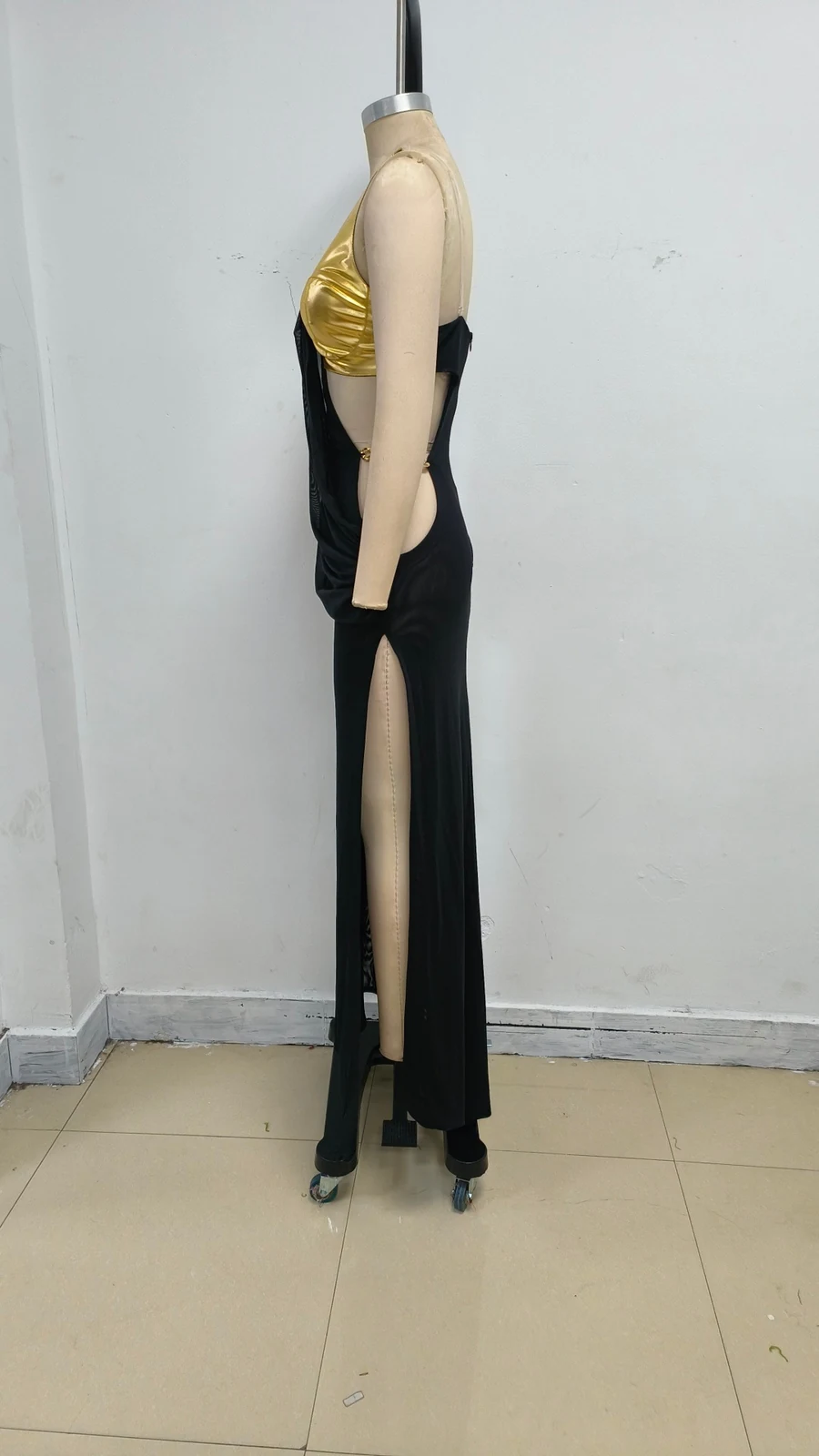 Real photo of black maxi dress on a mannequin showing the high slit