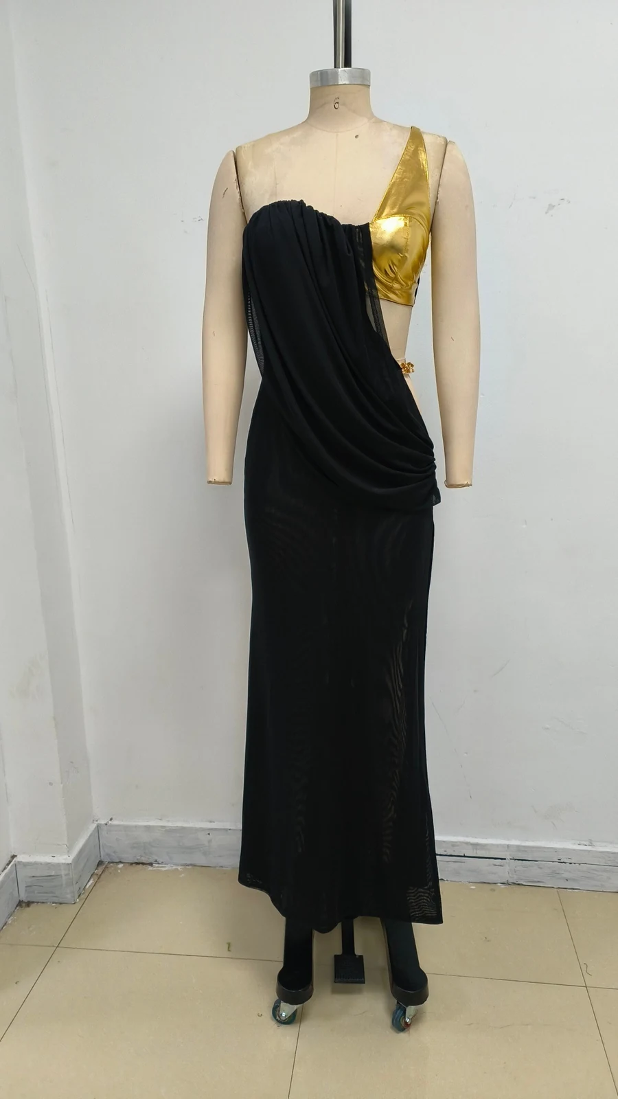 Real photo of black one-shoulder gold accent maxi dress on a mannequin