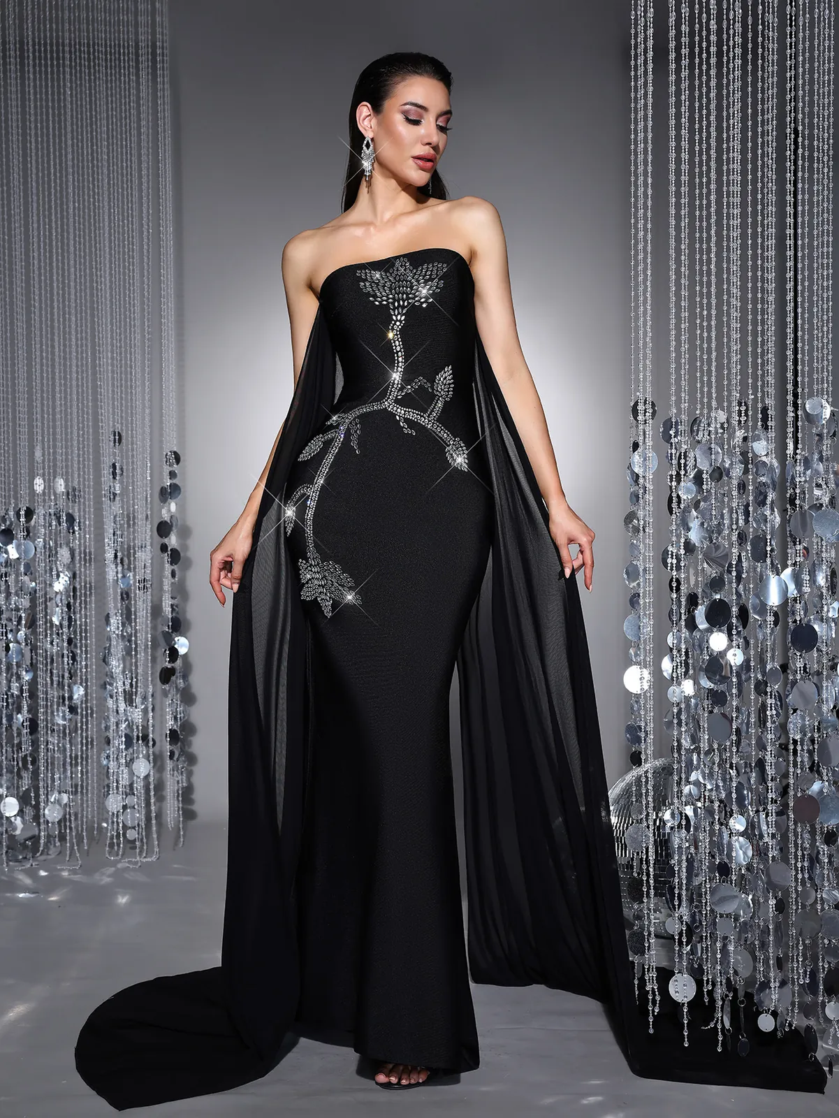 Black strapless rhinestone embroidered bandage gown with flowing mesh drapes