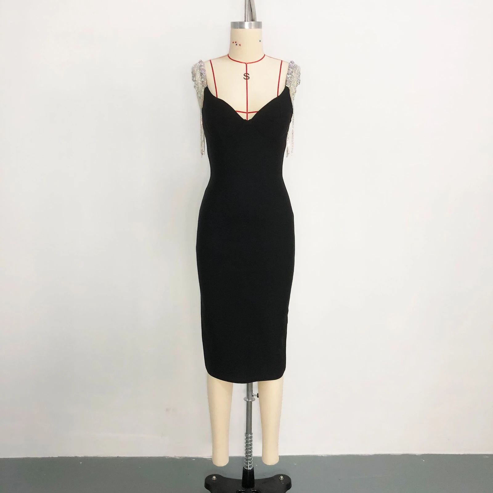 Real photo of black V neck bandage dress with rhinestone fringe straps on a mannequin