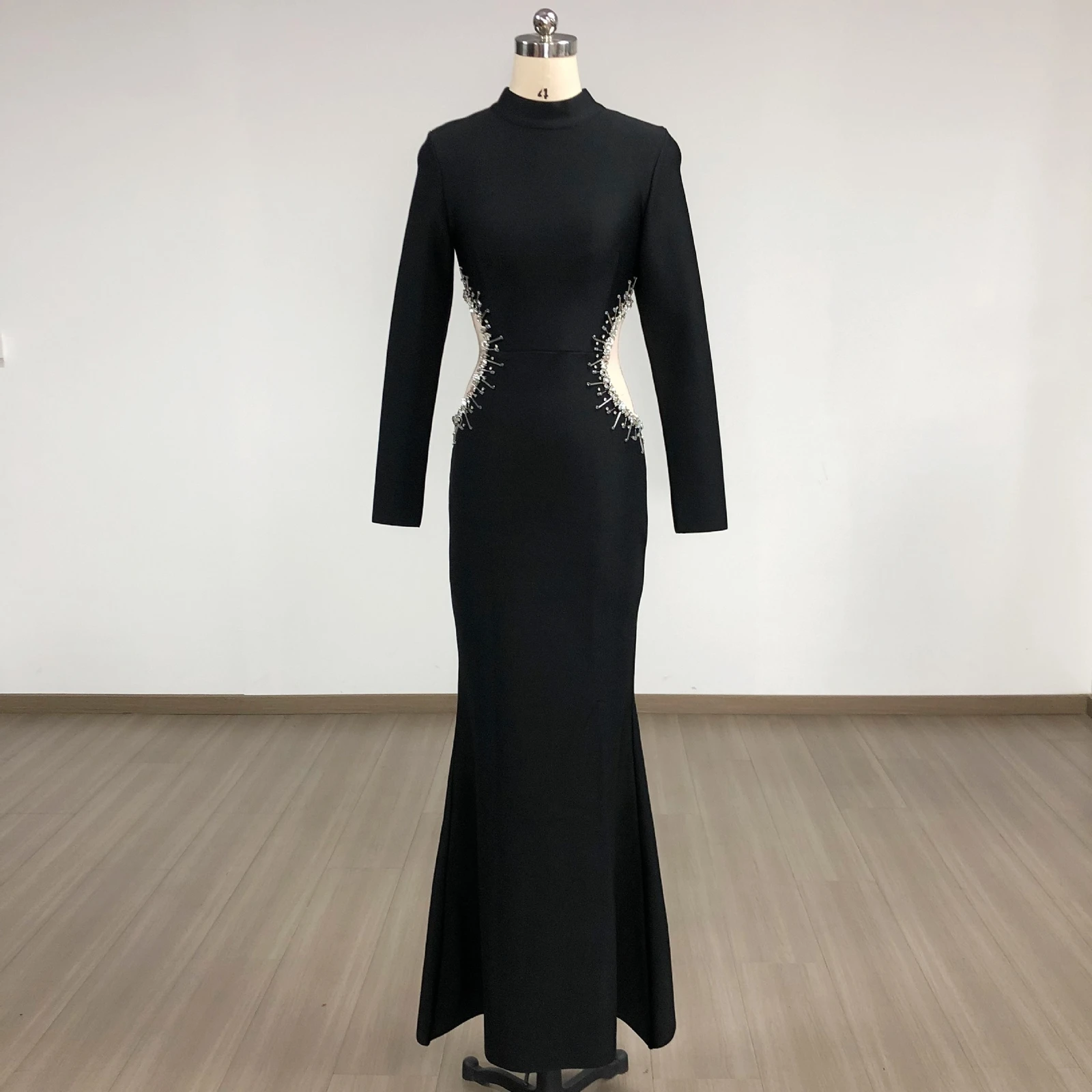Real photo of black long sleeve bandage mermaid maxi dress with rhinestone mesh cut-outs on a mannequin