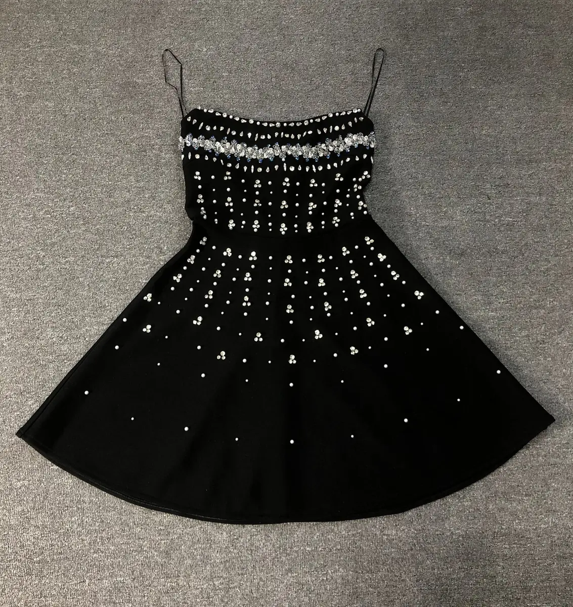 Flat lay of black rhinestone strapless A-line bandage mini dress