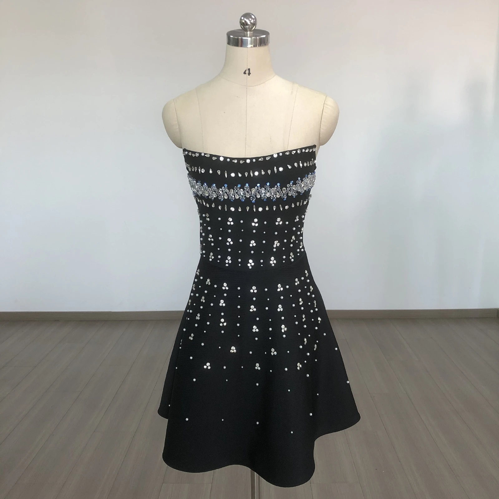 Real photo of black rhinestone strapless A-line bandage mini dress on a mannequin