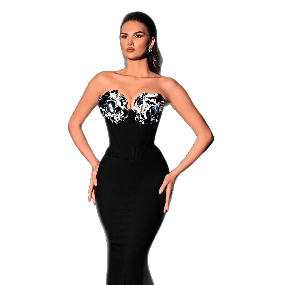 Model wearing black strapless 3D flower mermaid dress on white background