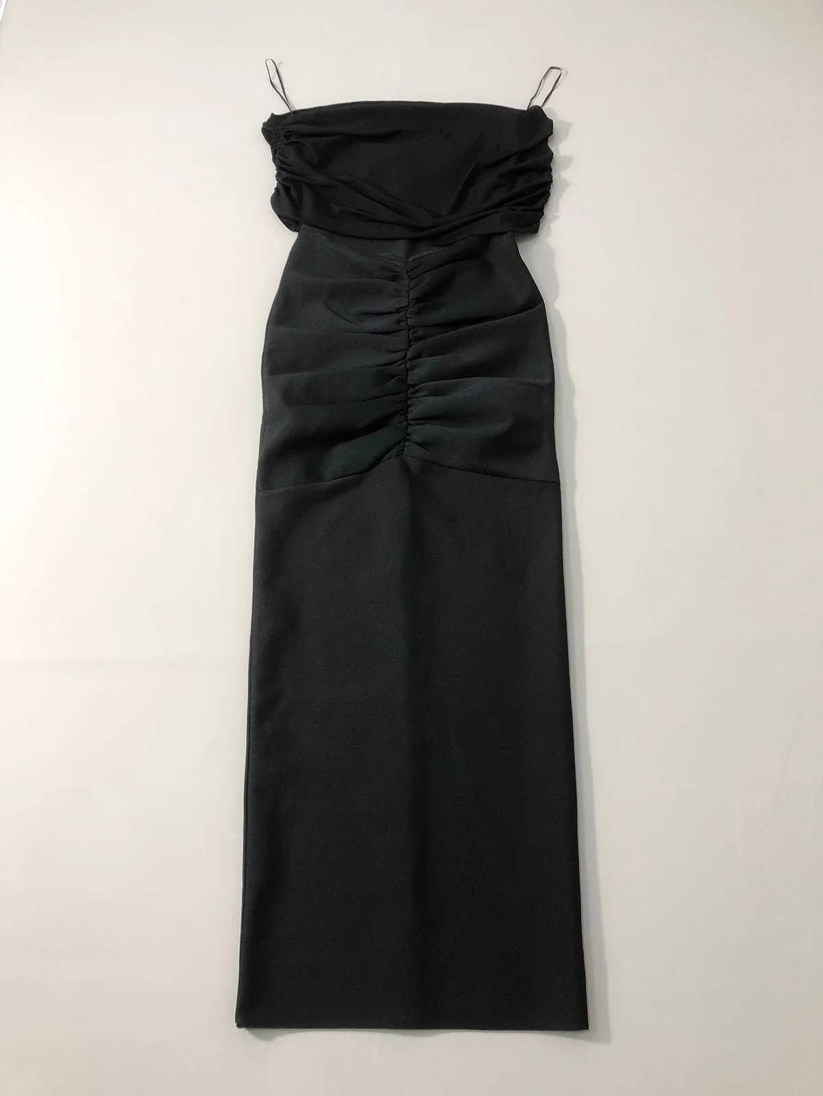 Flat lay of the black strapless ruched bandage maxi dress from the two piece set