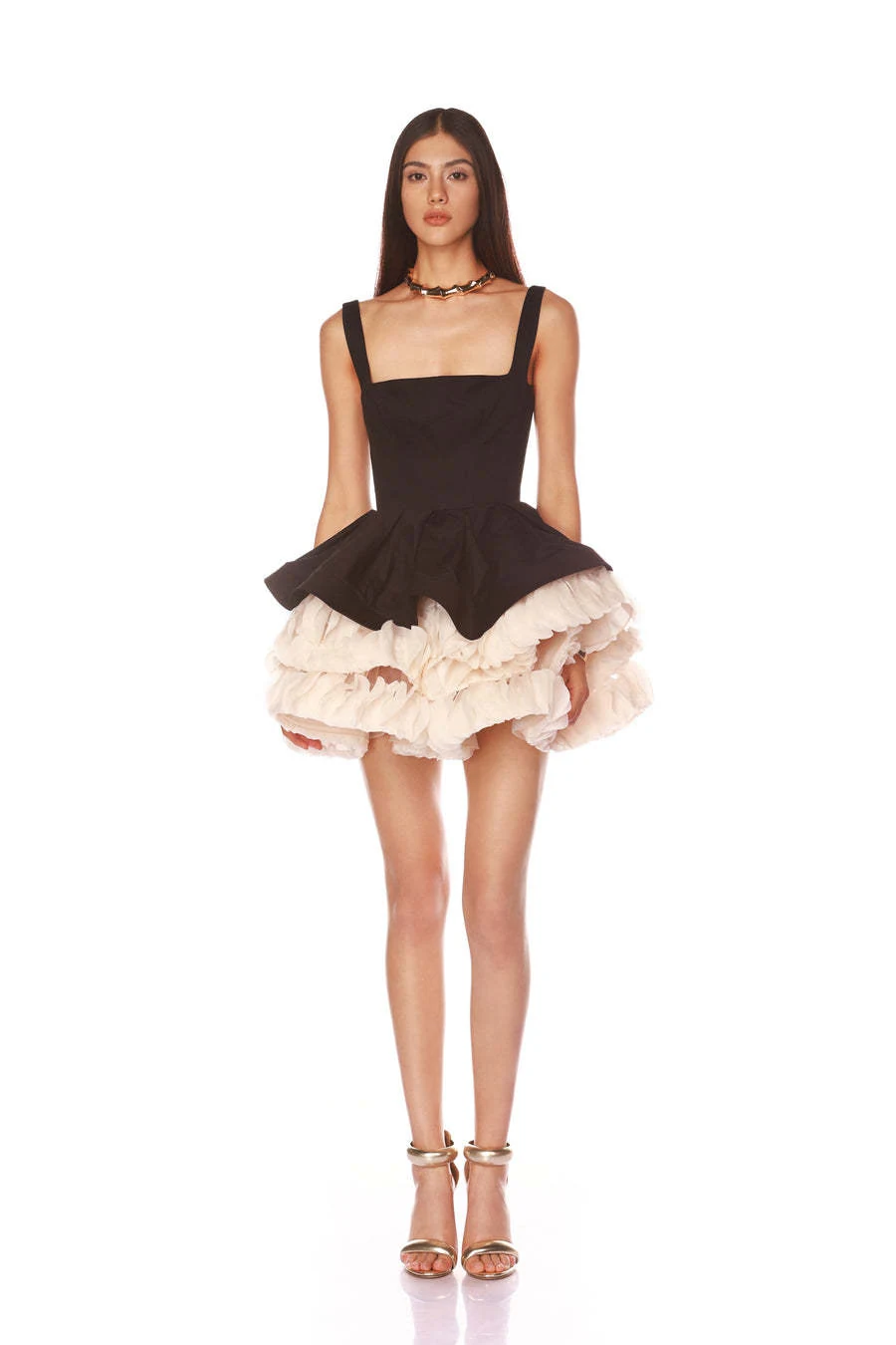 Model wearing black square neck puffball mini dress with cream ruffle hem, front view