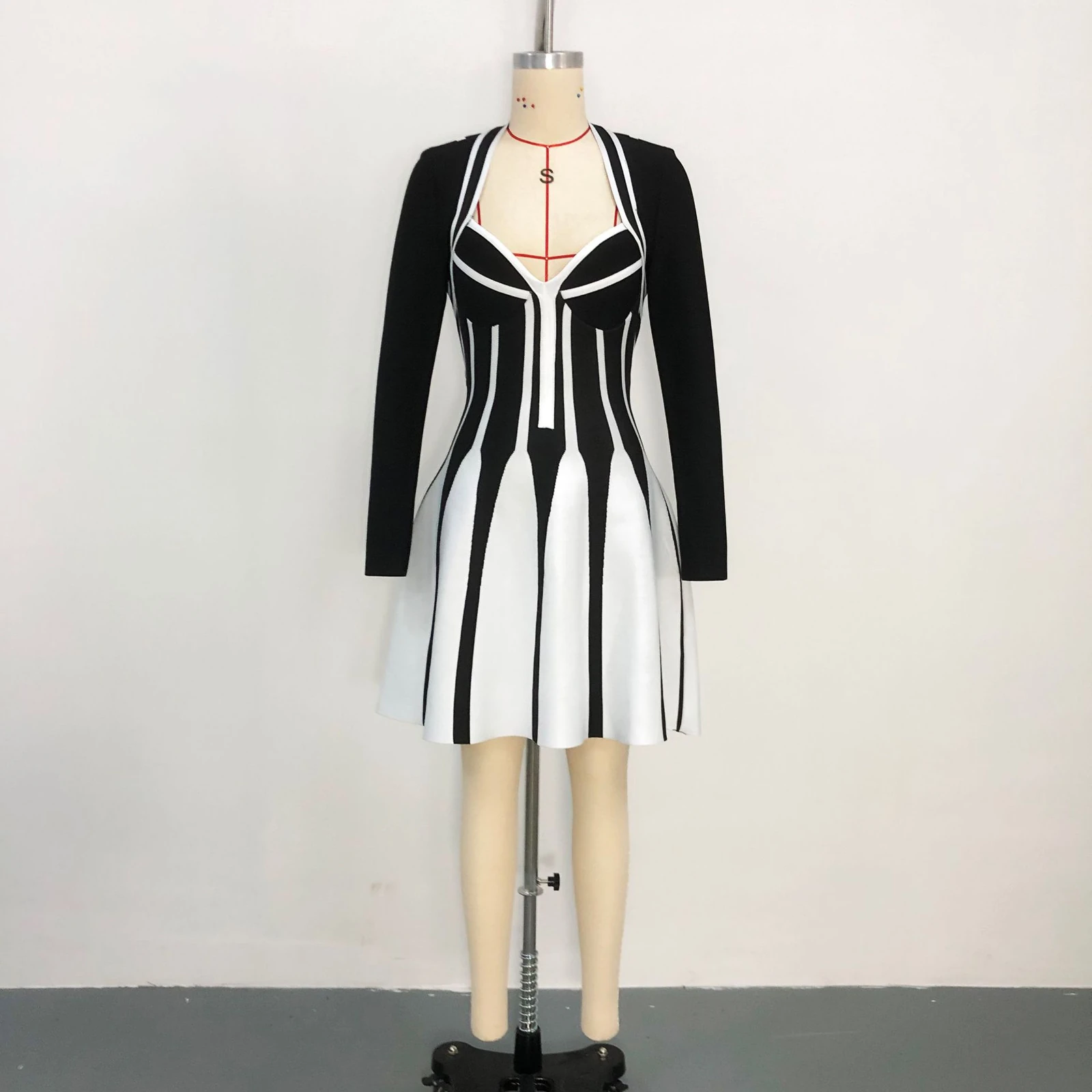 Real photo of black and white stripe jacquard knit long sleeve mini dress on a mannequin