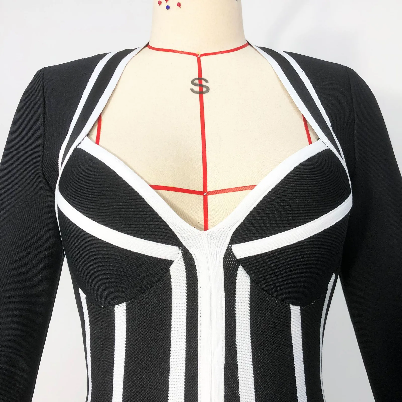 Close-up real photo of the neckline on black and white stripe jacquard knit mini dress
