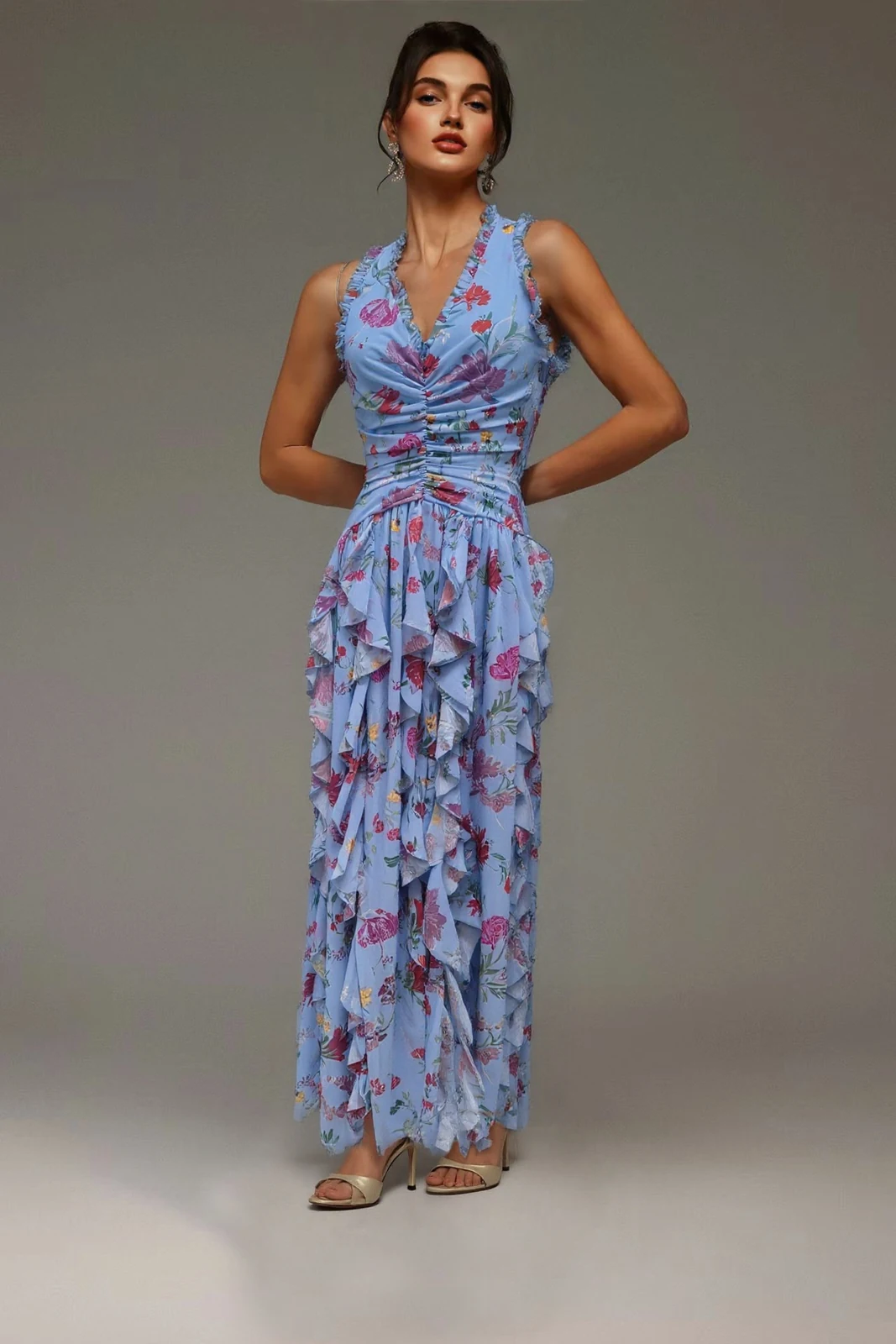 Model wearing blue floral print halter ruffle maxi dress, front view