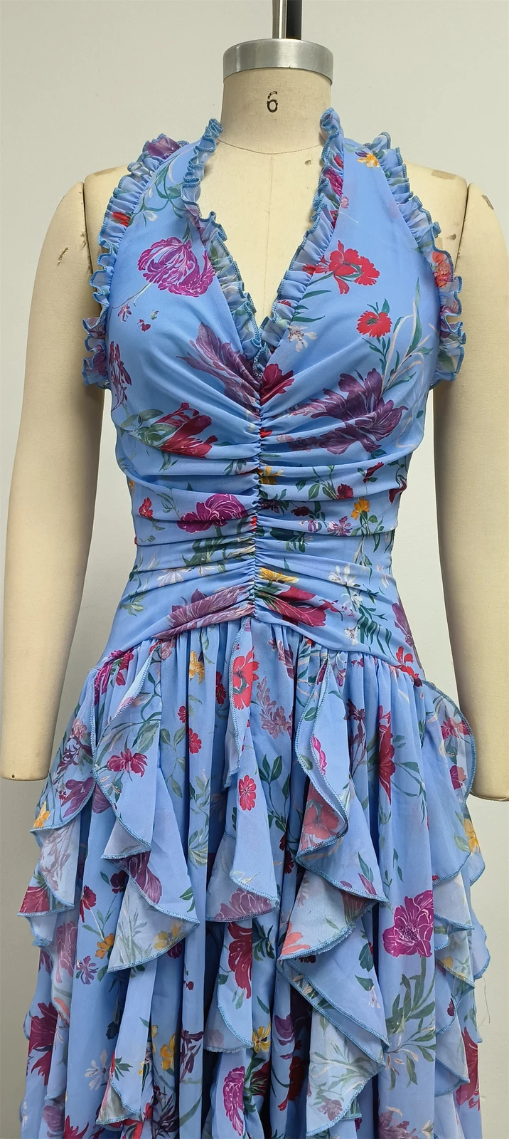 Real photo of blue floral halter ruffle maxi dress on a mannequin