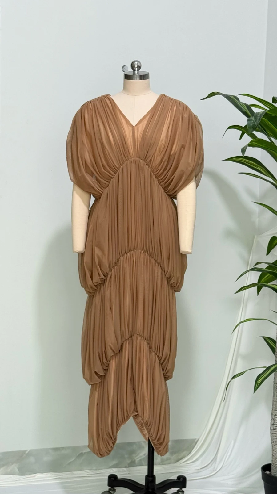 Real photo of brown deep V tiered ruched maxi dress on a mannequin