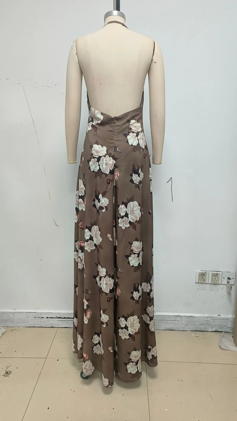 Real photo of brown floral satin maxi dress on a mannequin, back view