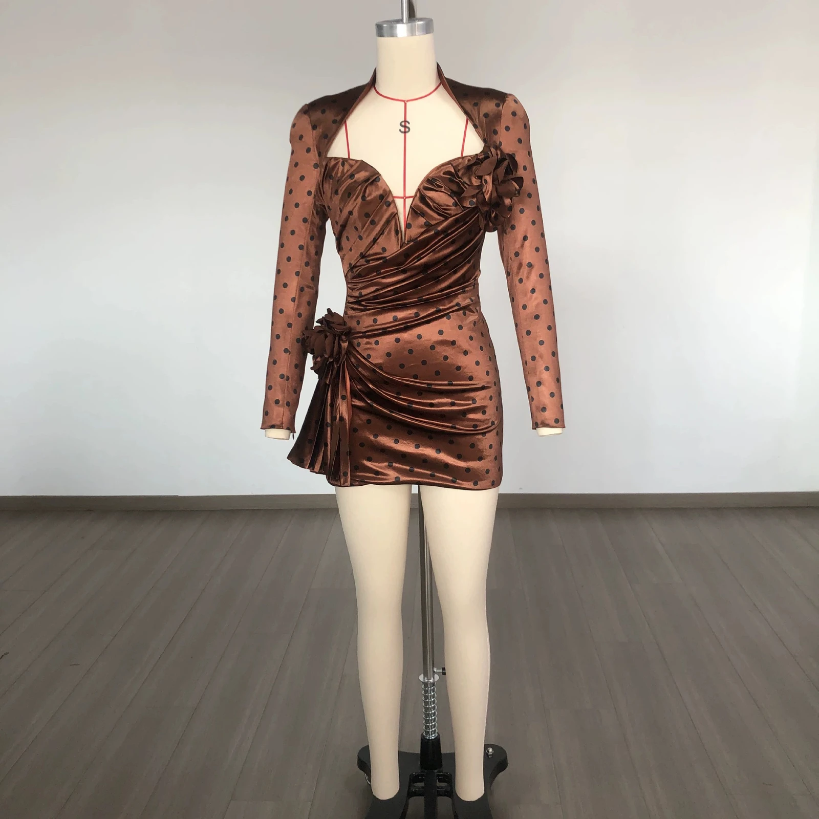 Real photo of brown polka dot deep V long sleeve ruched mini dress on a mannequin