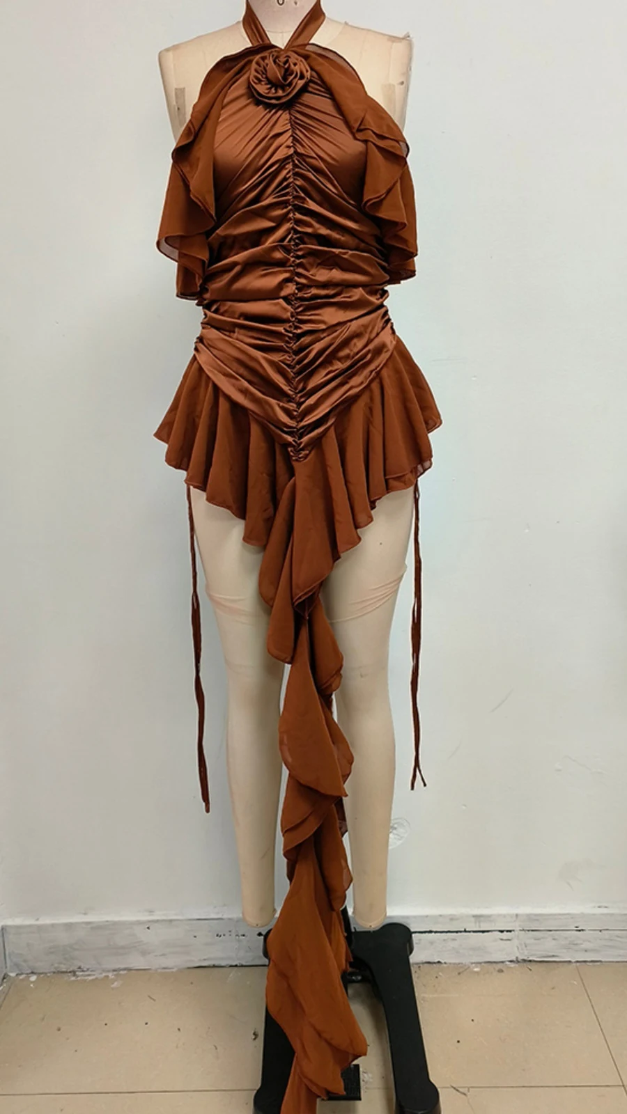 Real photo of caramel brown ruffle mini dress on a mannequin