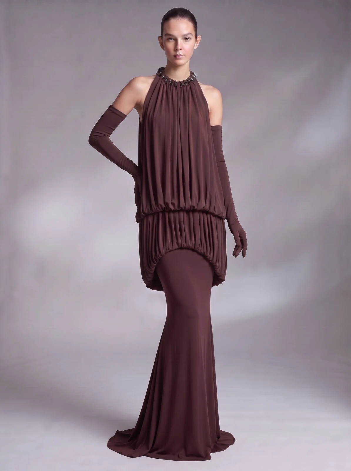 Model wearing coffee halter draped blouson mermaid maxi dress with gloves, front view