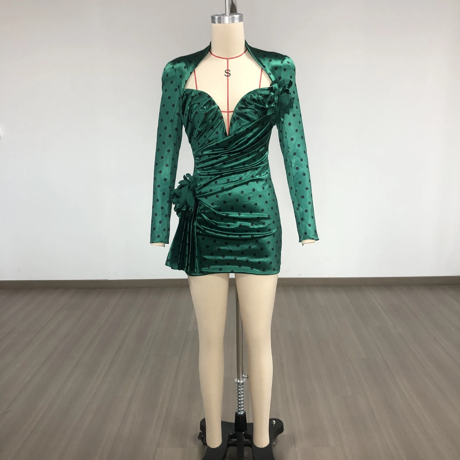 Real photo of green polka dot deep V long sleeve ruched mini dress on a mannequin