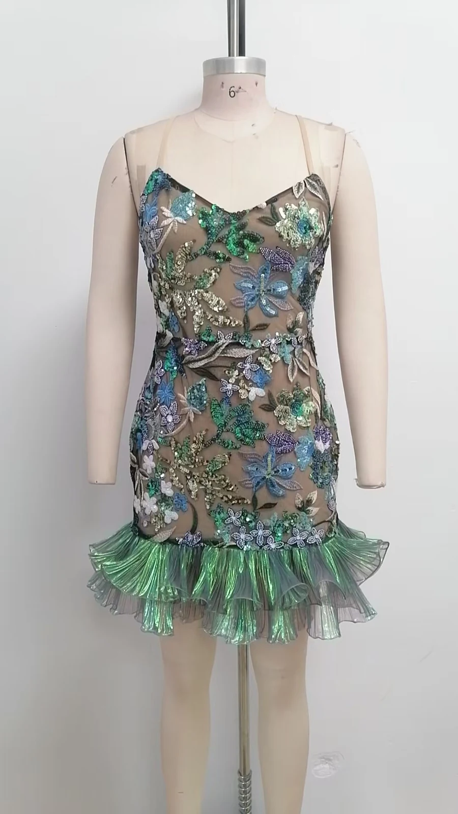 Real photo of green sequin floral mini dress on a mannequin