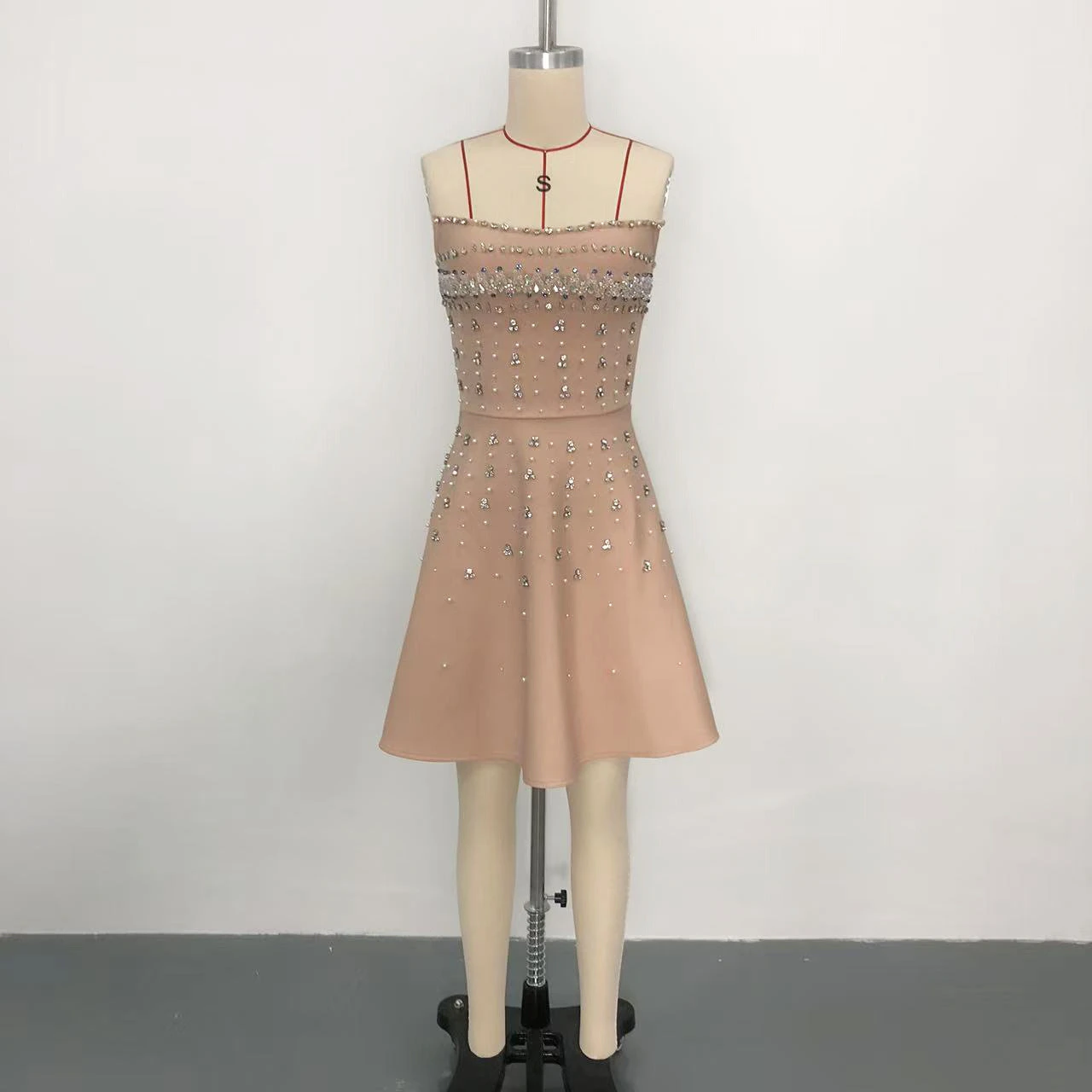 Real photo of light orange rhinestone strapless A-line bandage mini dress on a mannequin