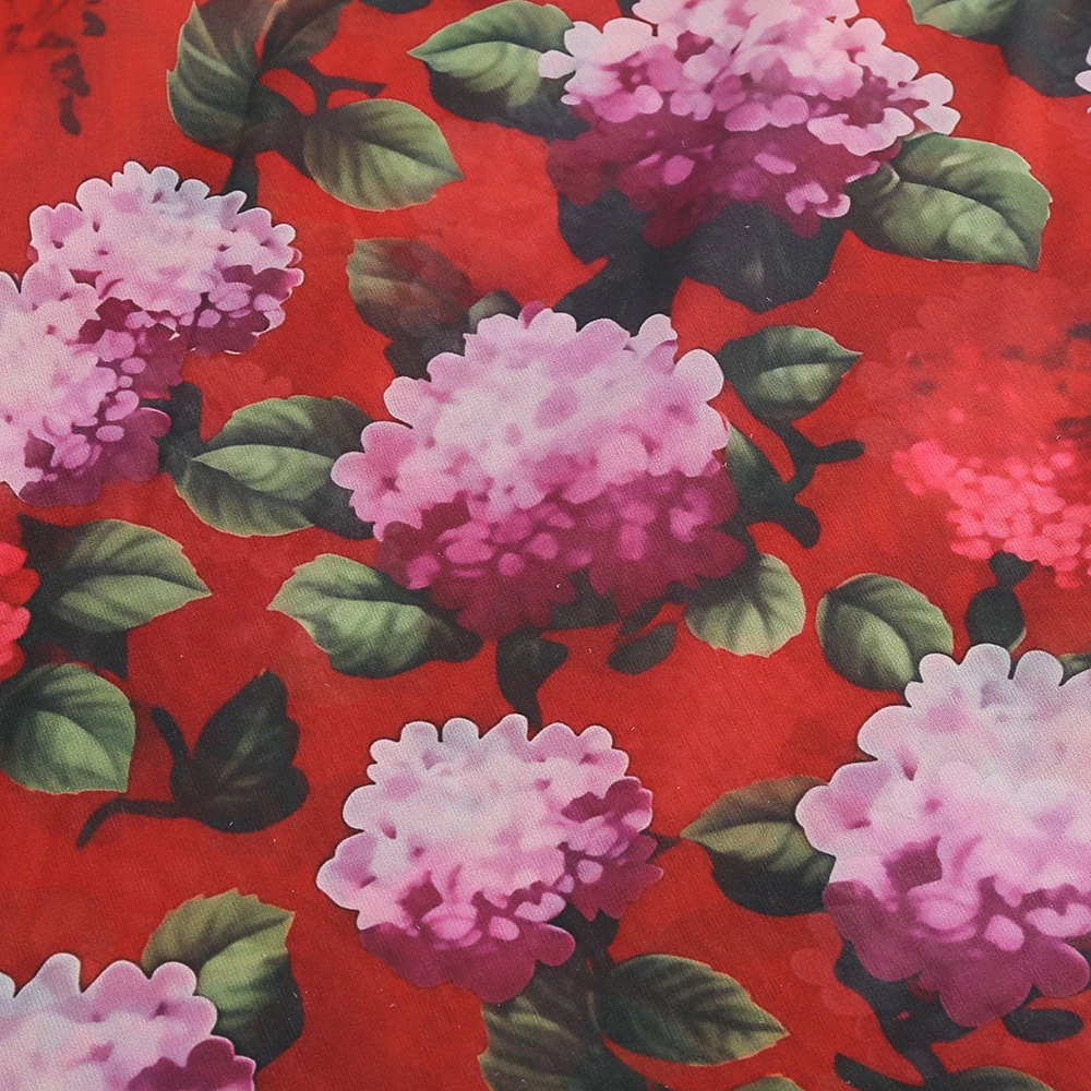 Close-up of the floral print on multi strapless floral draped high slit maxi dress