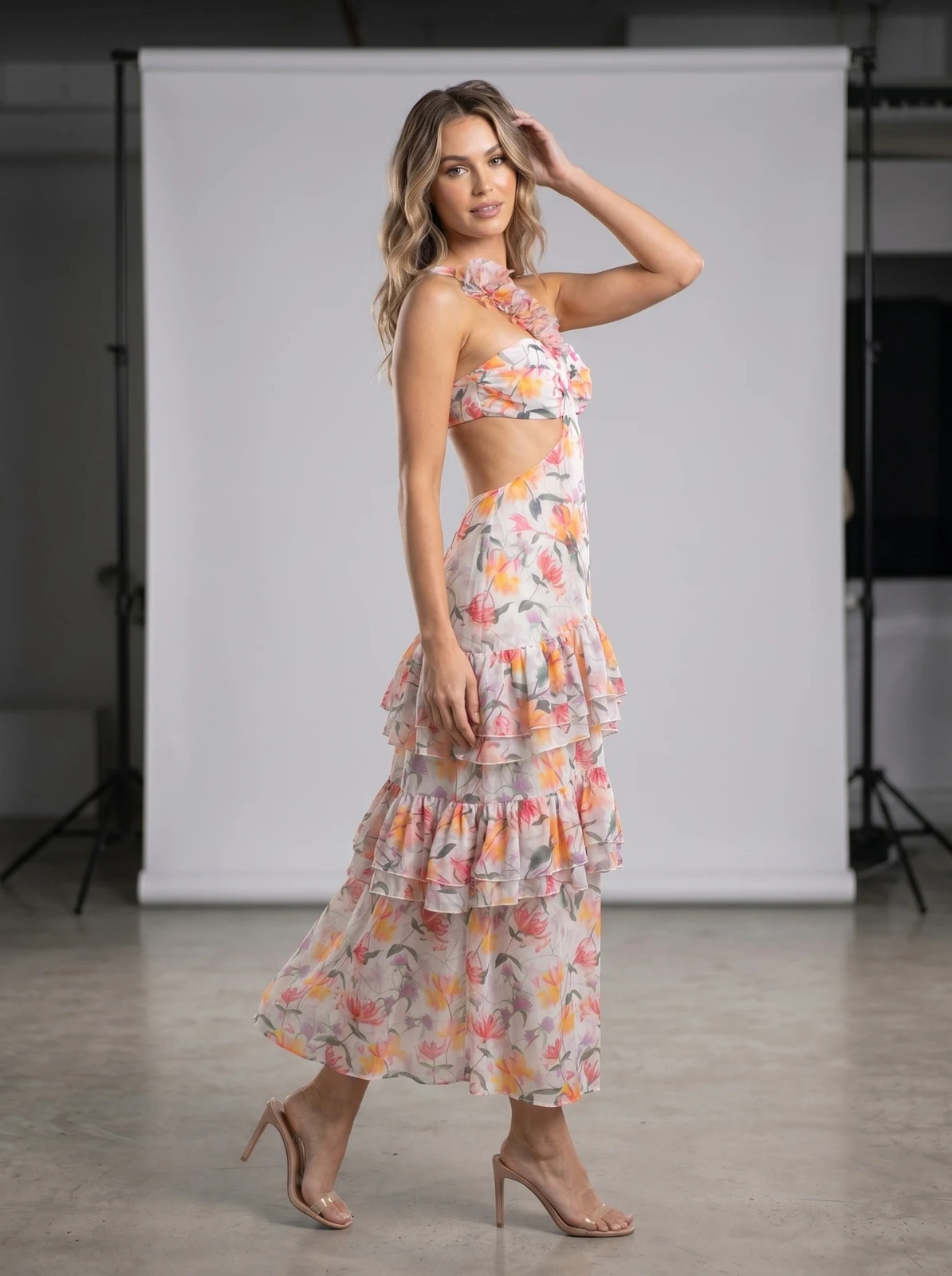 Model in multicolour floral one-shoulder maxi dress showing the cut-out back