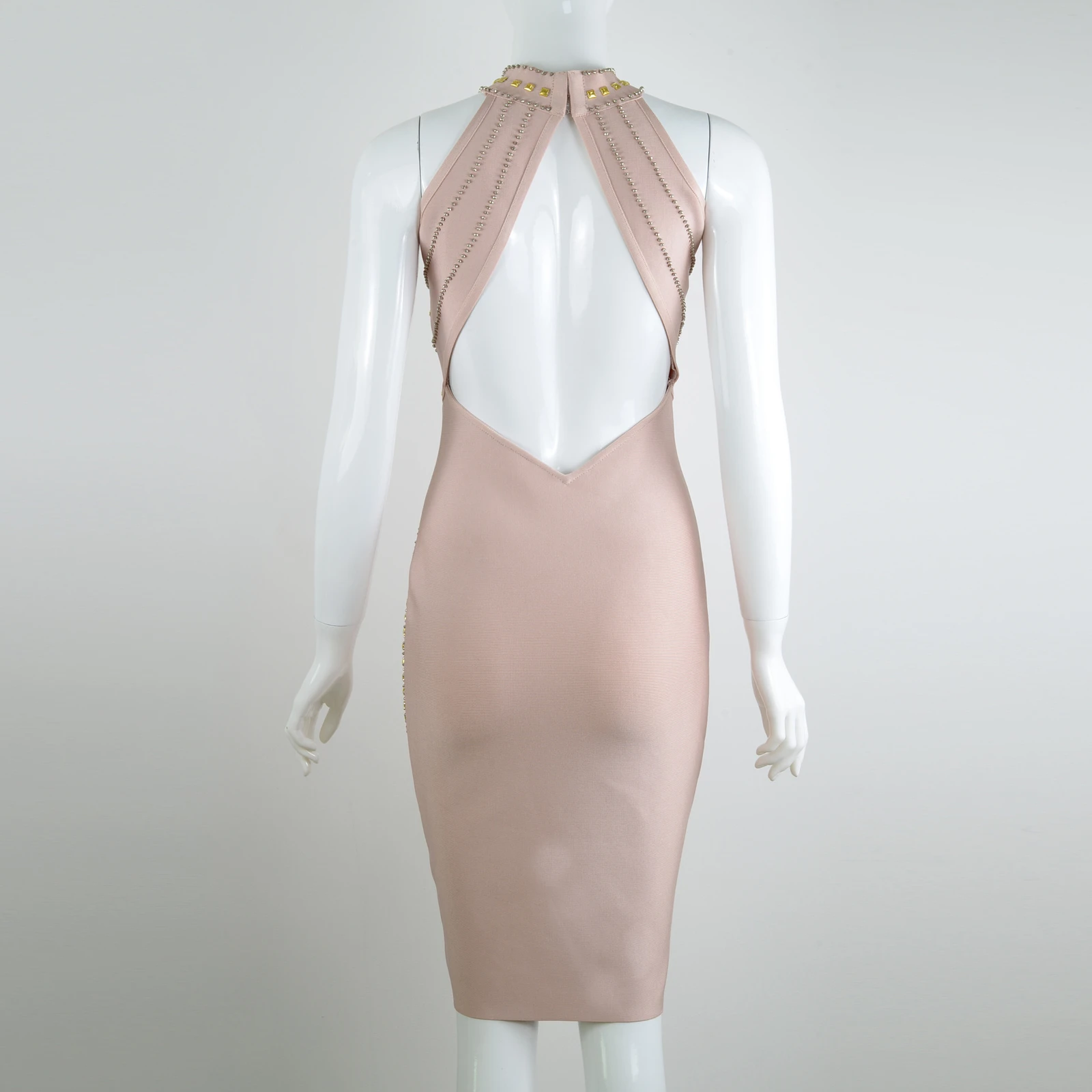 Real photo of the open back of nude studded mesh halter bandage midi dress on a mannequin