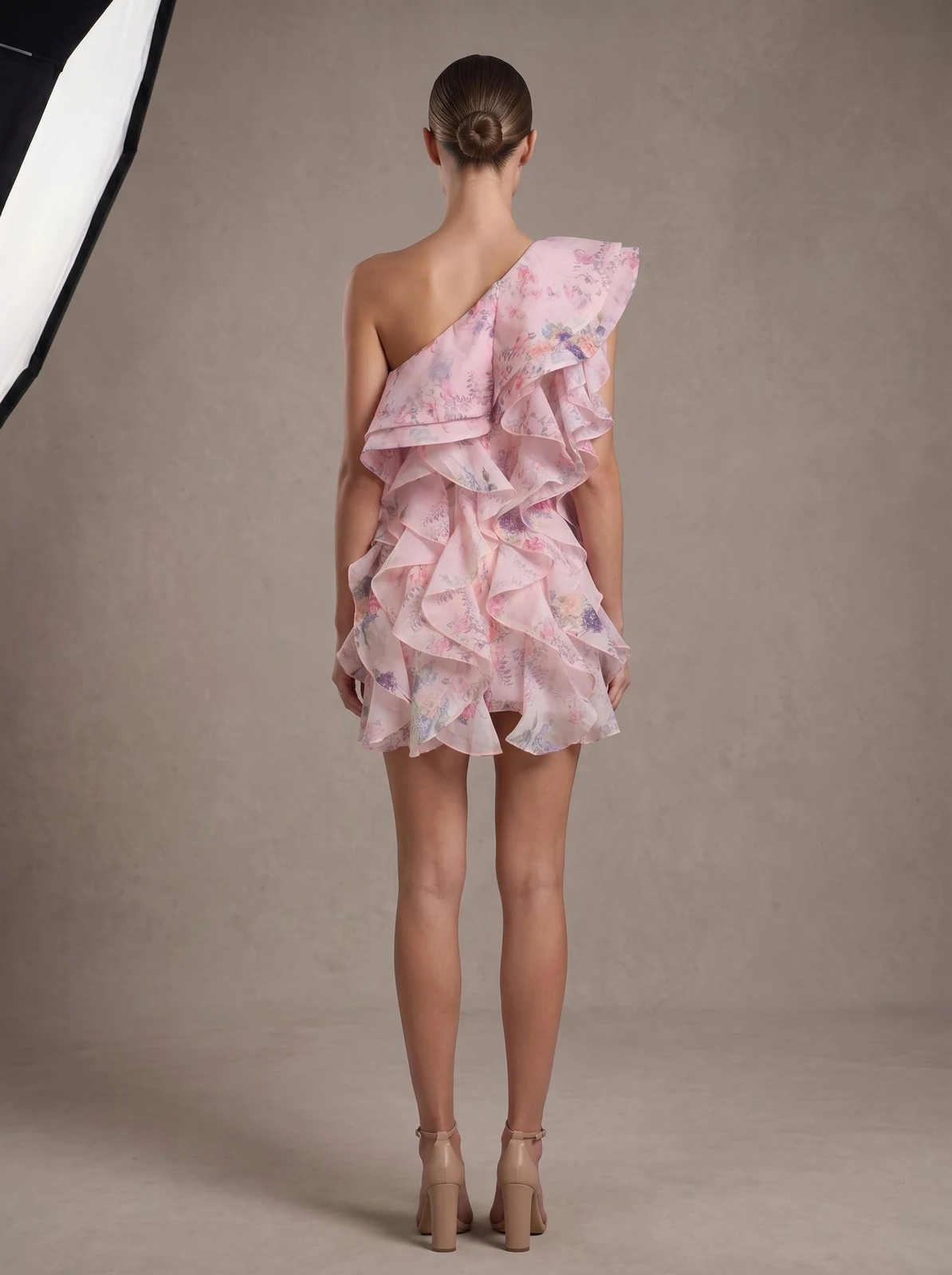 Back view of pink one-shoulder floral ruffle mini dress