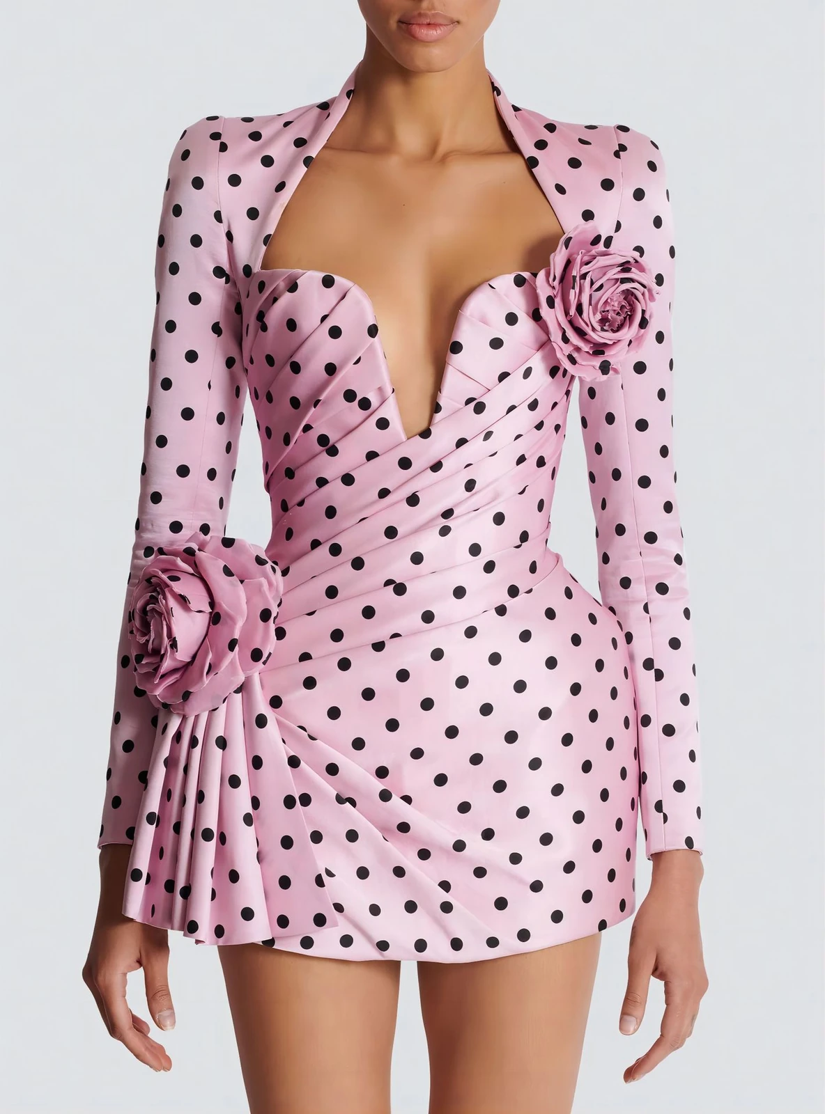 Close-up of deep V neckline, 3D rose flowers and ruched pleats on pink polka dot mini dress