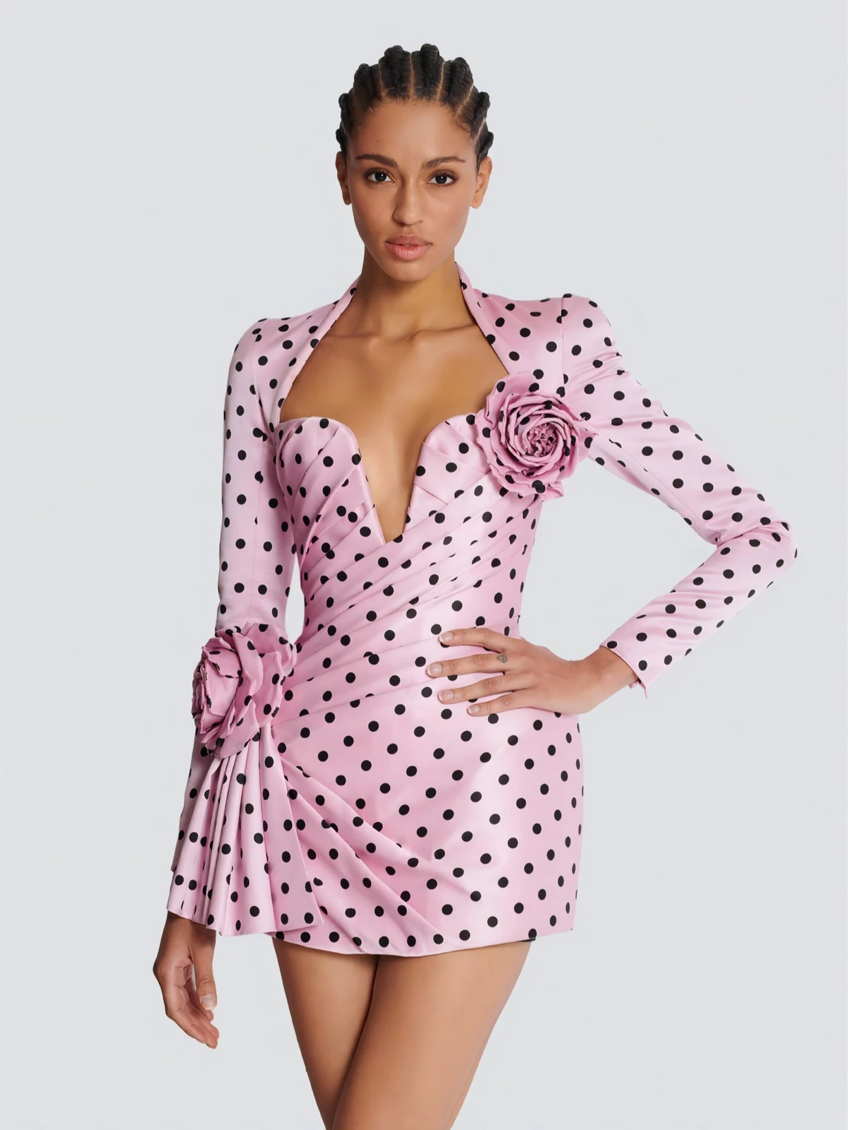 Model wearing pink polka dot deep V long sleeve mini dress with 3D rose flowers and ruched waist, front view