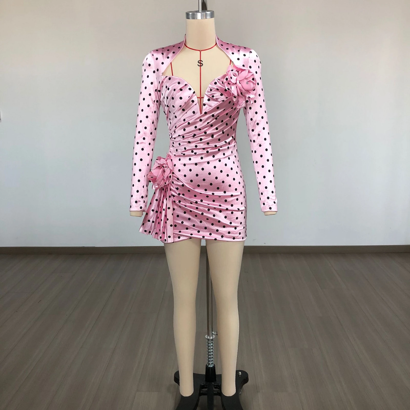 Real photo of pink polka dot deep V long sleeve mini dress with rose detail on a mannequin