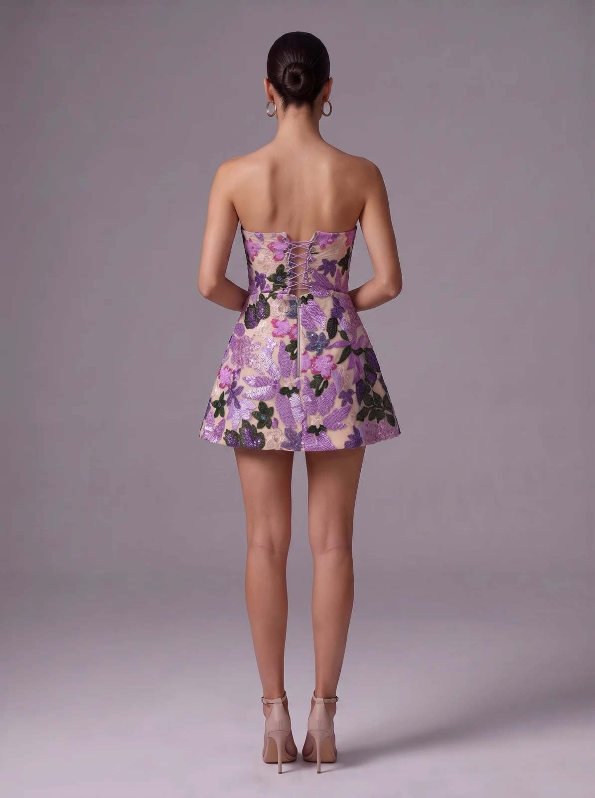 Back view of purple strapless sequin floral A-line mini dress