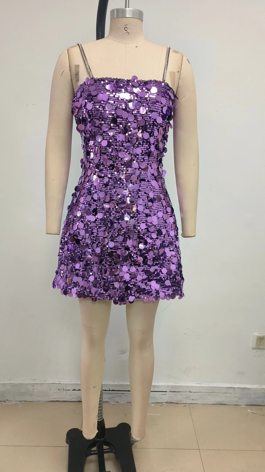 Real photo of purple sequin mini dress on a mannequin