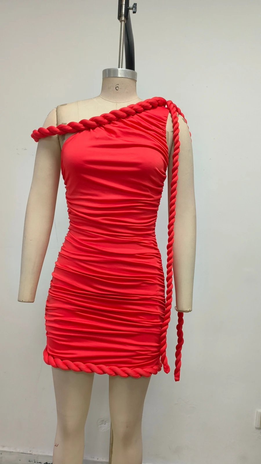 Real photo of red one-shoulder rope trim mini dress on a mannequin