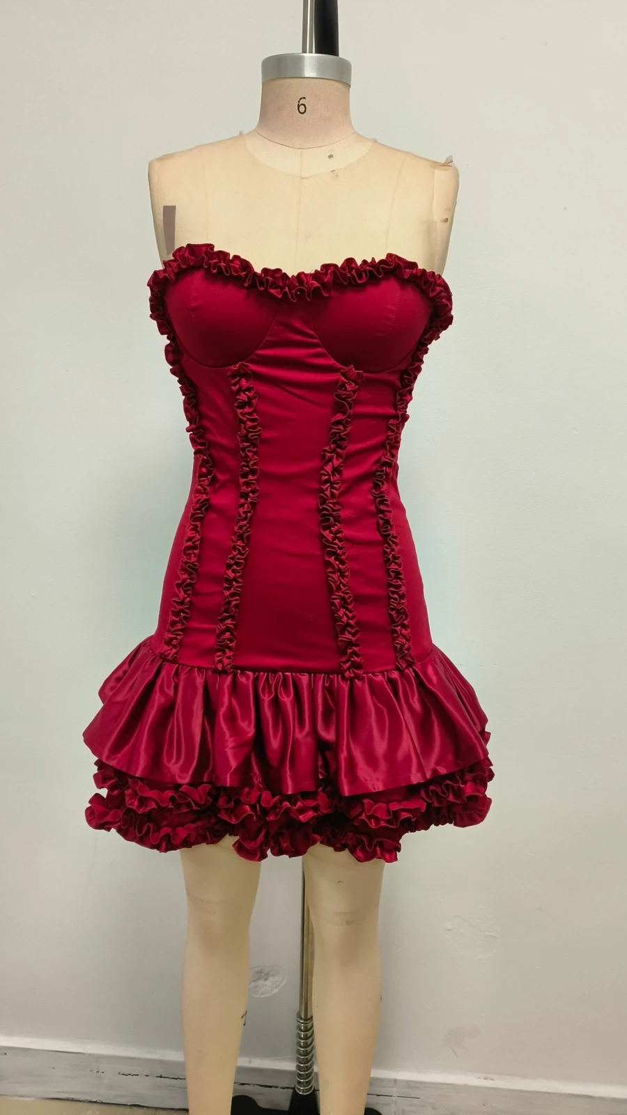 Real photo of red strapless ruffle corset mini dress on a mannequin