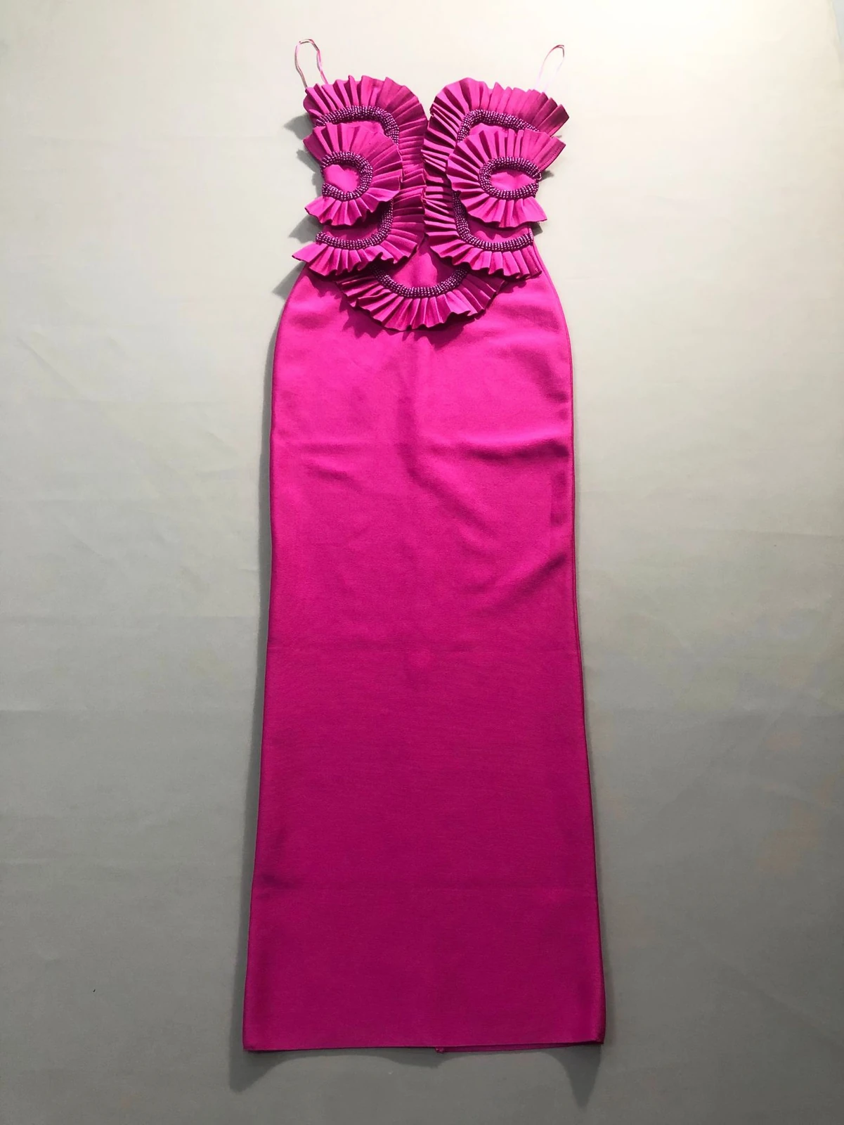 Flat lay of rose red strapless ruffle beaded bandage maxi dress