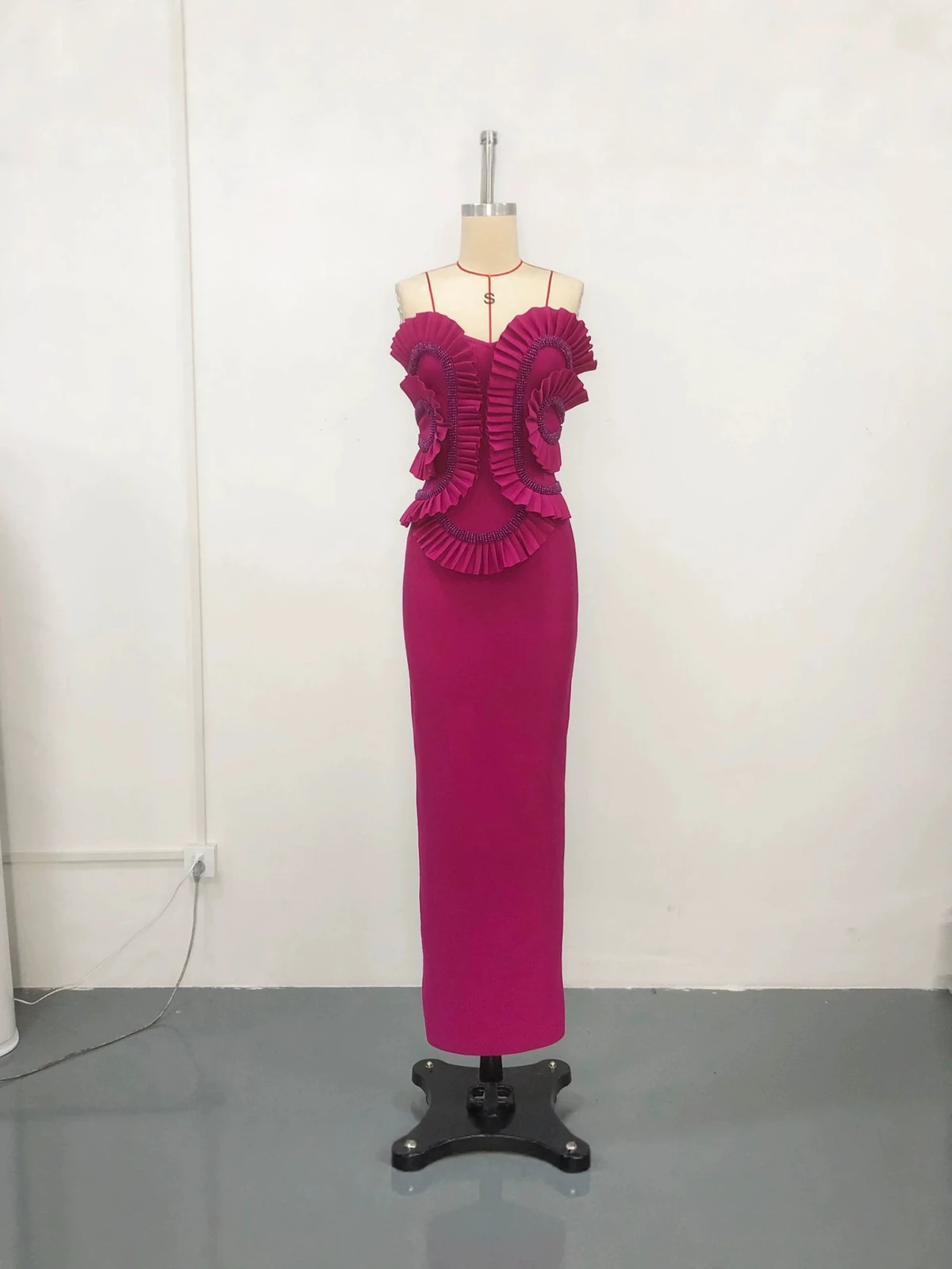 Real photo of rose red strapless bandage maxi dress with ruffled beaded bodice on a mannequin