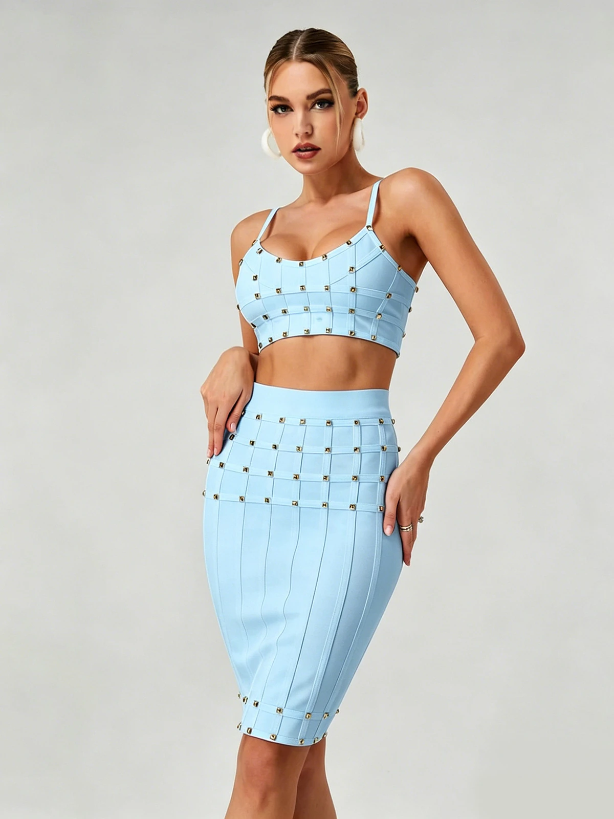 Close-up of sky blue studded cami crop top and high-waist bandage skirt
