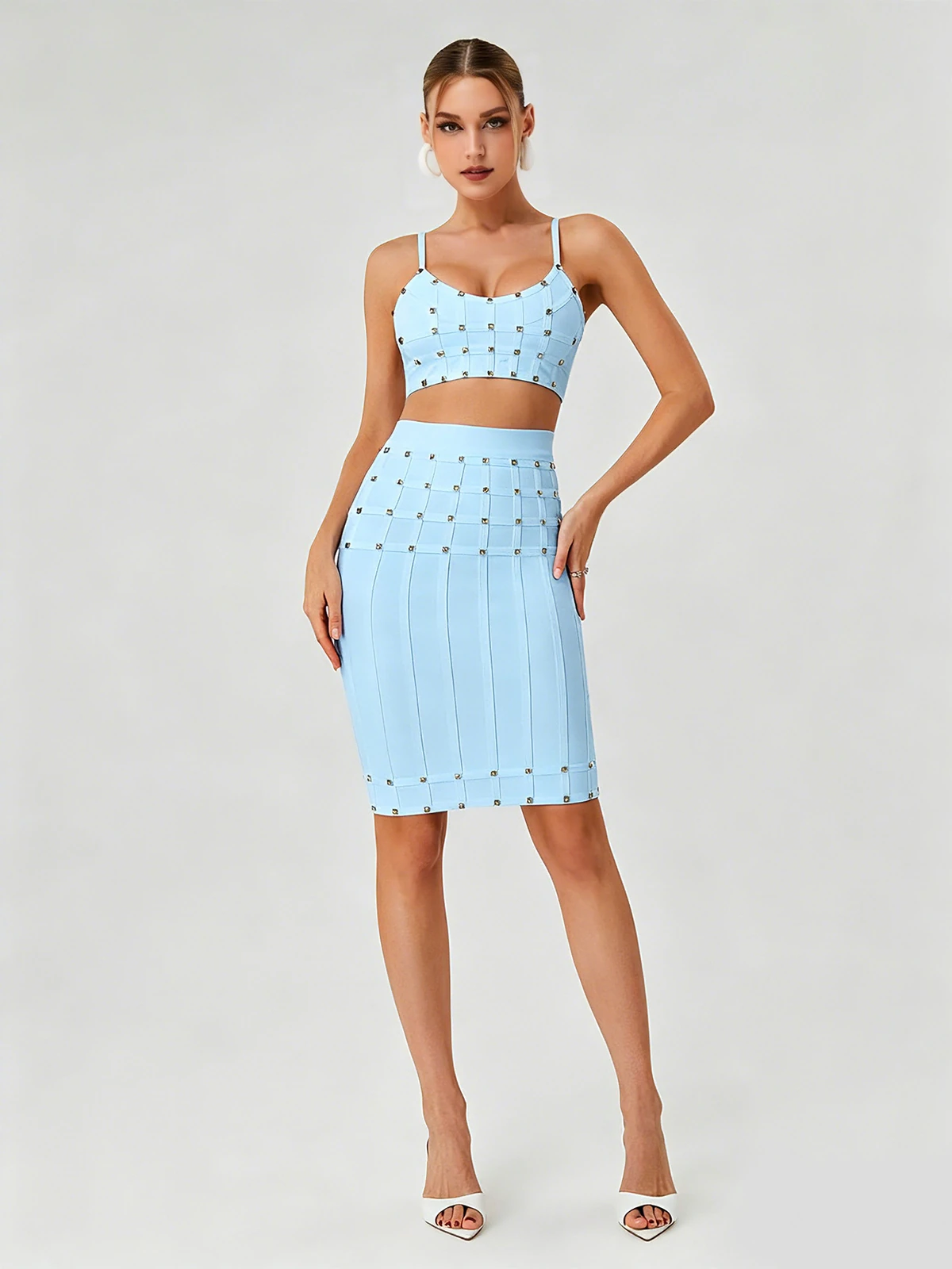 Model wearing sky blue studded cami crop top and bandage pencil skirt two-piece set, front view