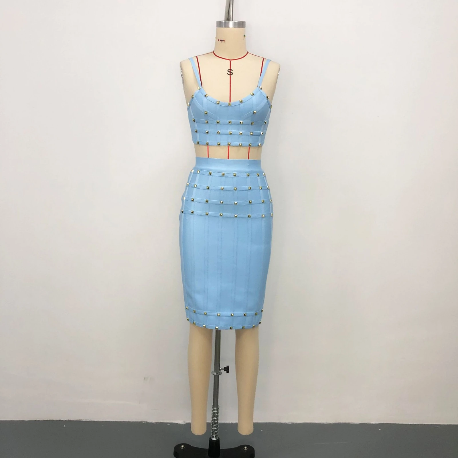 Real photo of sky blue studded cami crop top and bandage skirt set on a mannequin