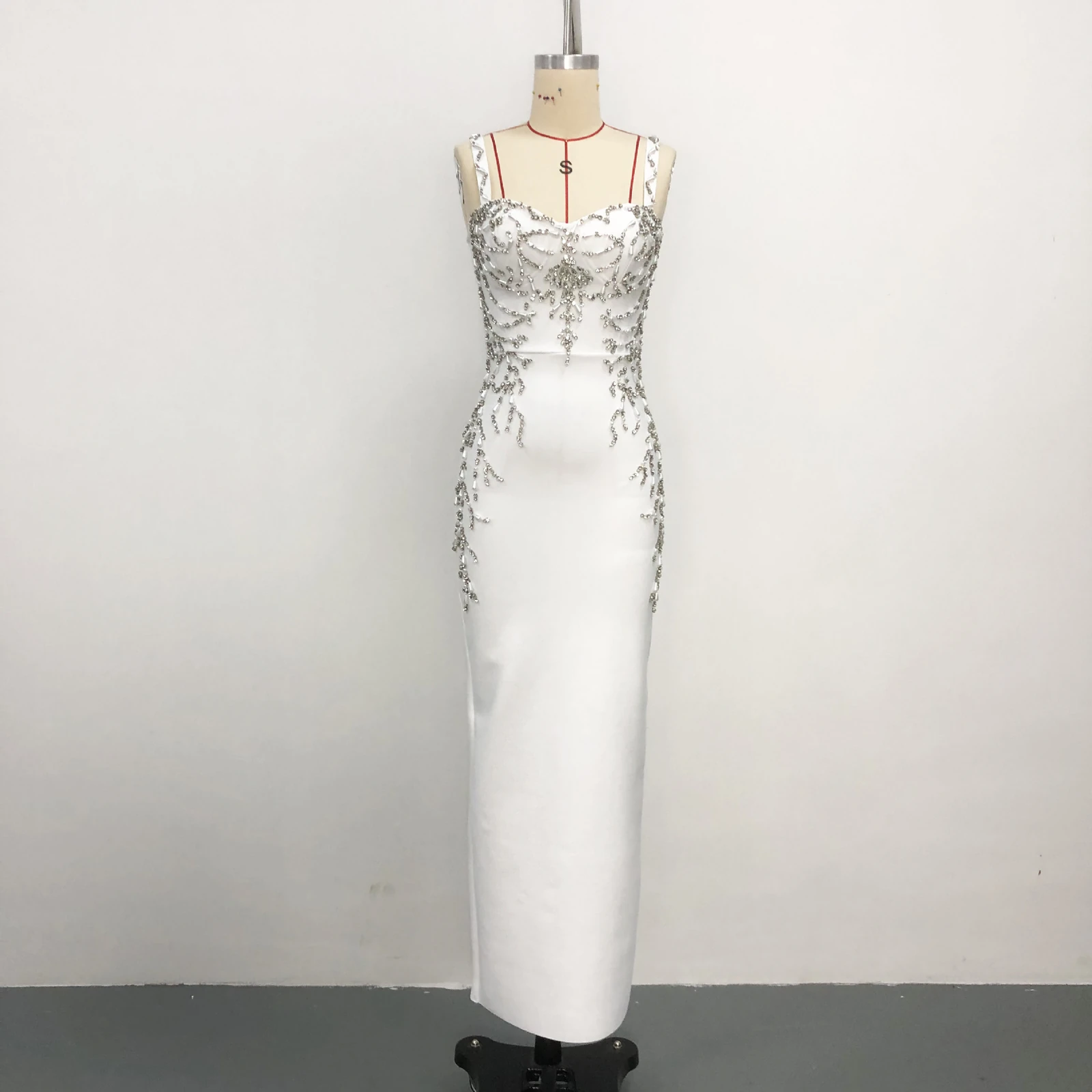 Real photo of white beaded spaghetti strap bandage maxi dress on a mannequin