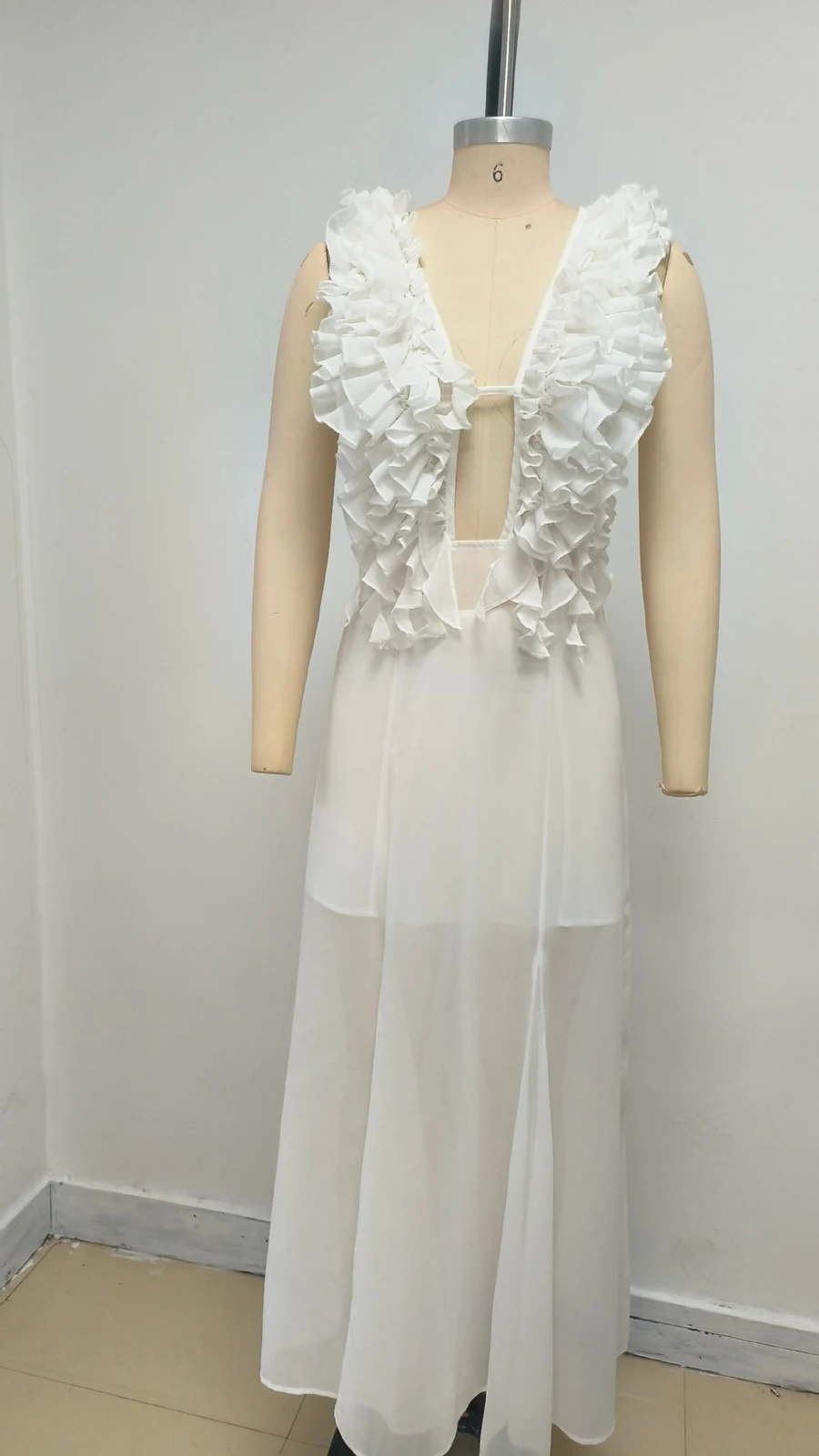 Real photo of white deep V ruffle maxi dress on a mannequin
