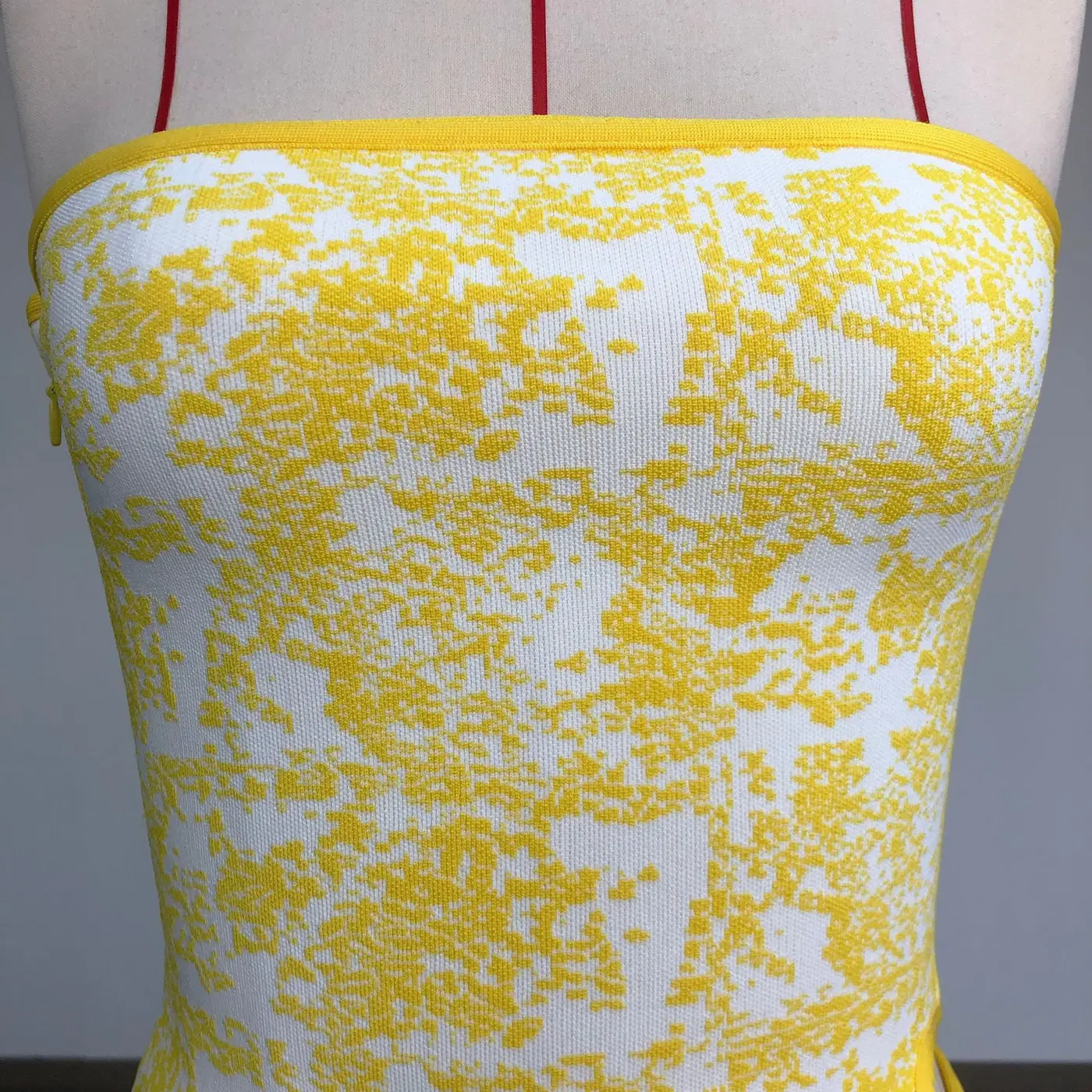 Close-up real photo of the yellow and white jacquard pattern on the strapless bandage top