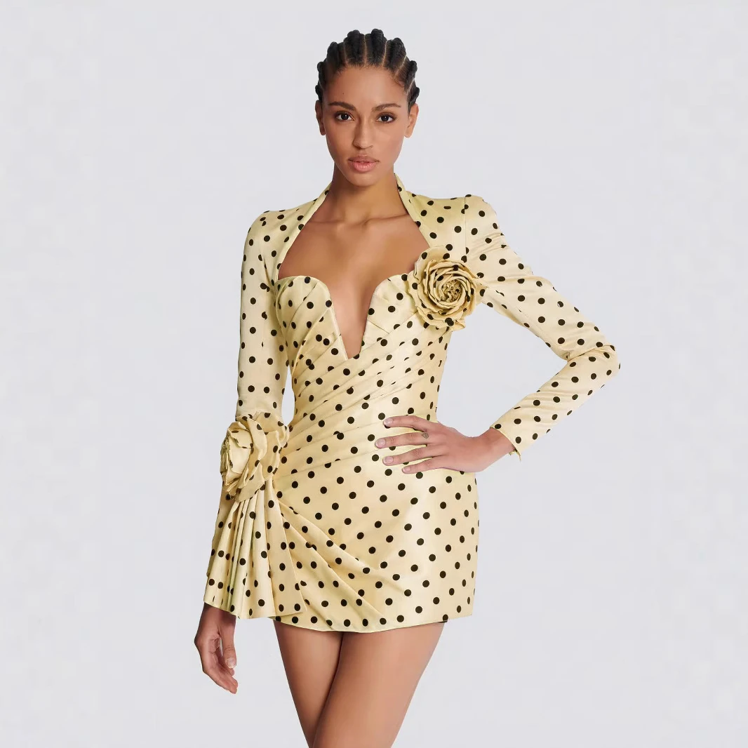 Model wearing yellow polka dot deep V long sleeve mini dress with 3D rose flowers