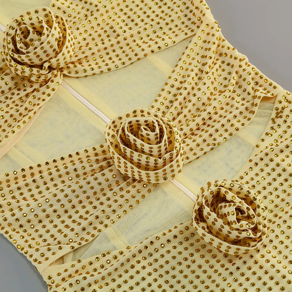 Close-up of the 3D rosettes on yellow rhinestone mesh cut-out mini dress