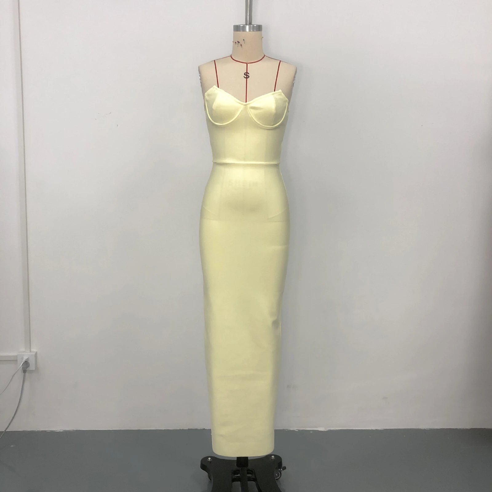 Real photo of pale yellow strapless sweetheart bandage maxi dress on a mannequin